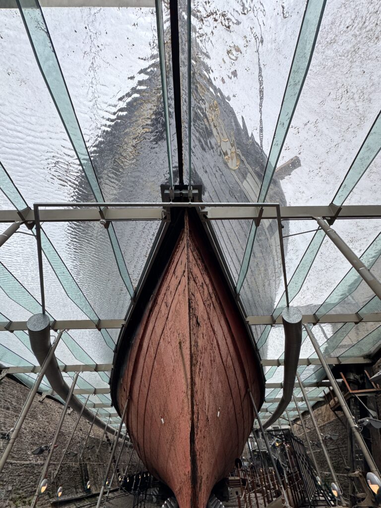 Looking up at the hull of the SS Great Britain from below through the glass dry dock structure